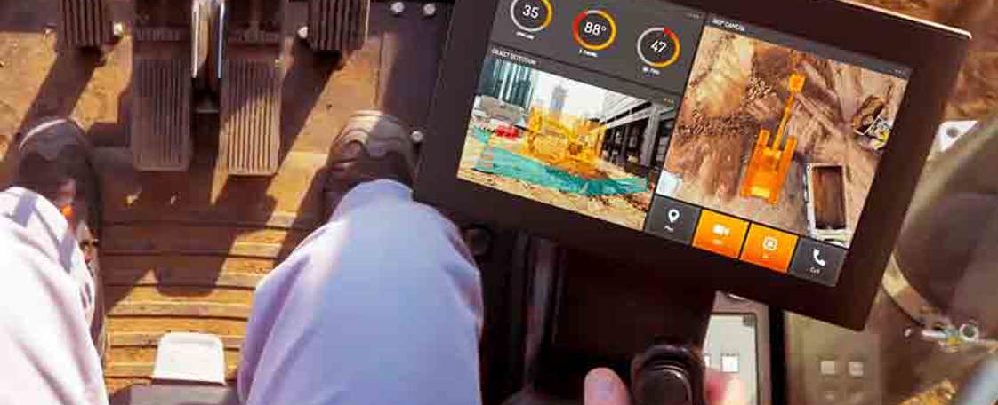 CCpilot V1000 in construction cabin with man driving.