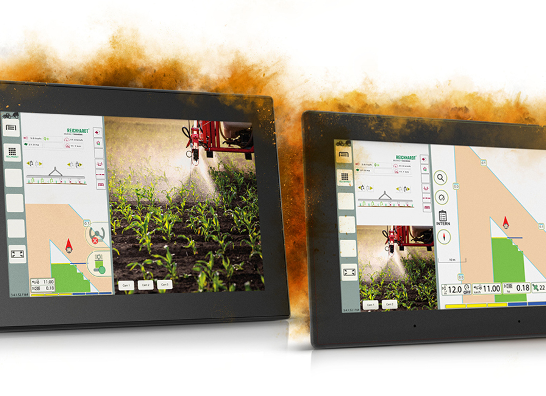 Two displays beside each other with agricultural HMI with orange dust cloud